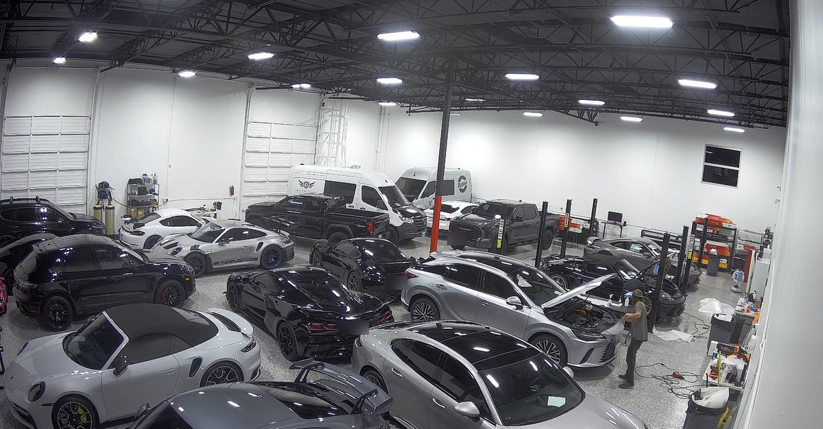 Inside the Veros Premium Car Care detail shop in Rancho Cucamonga, California, with Porsche, Corvette, and luxury vehicles in for paint correction, ceramic coating, and paint protection film