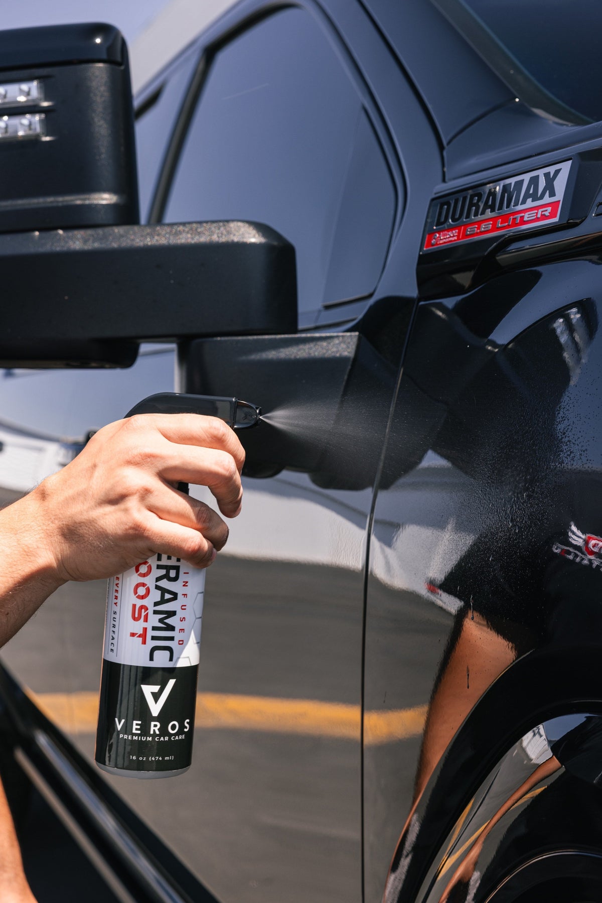 Spraying Ceramic Boost on a truck